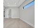 Spacious living room featuring a modern design with a large window and neutral color palette at 15 Tournament Rd, Rotonda West, FL 33947