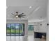 Bright living room featuring sliding glass doors to the pool, and sleek ceiling fan at 15 Tournament Rd, Rotonda West, FL 33947