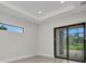 Bright living area with sliding glass doors to the outdoors and a sleek, modern design at 15 Tournament Rd, Rotonda West, FL 33947
