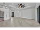 Spacious living room with modern lighting, tile flooring, and access to outdoor spaces at 15 Tournament Rd, Rotonda West, FL 33947