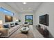 Bright living room with modern decor, large windows, and access to the outdoor area at 15 Tournament Rd, Rotonda West, FL 33947
