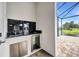 Outdoor kitchen featuring granite countertop, sink, and stainless steel beverage cooler at 15 Tournament Rd, Rotonda West, FL 33947