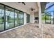 A covered patio area with an outdoor kitchen and ceiling fans at 15 Tournament Rd, Rotonda West, FL 33947
