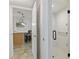 Modern bathroom featuring tiled shower, glass doors, grab bar and a view of a bar area at 1500 Park Beach Cir # 2F, Punta Gorda, FL 33950