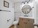 Bathroom with updated vanity, stylish fixtures, and a decorative 'Hello Sweet Cheeks' sign at 1500 Park Beach Cir # 2F, Punta Gorda, FL 33950