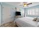 Bedroom featuring light blue walls, a ceiling fan, and natural light coming through the window at 1500 Park Beach Cir # 2F, Punta Gorda, FL 33950