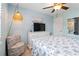 Bedroom with blue accents, a unique chair, and a white dresser with TV at 1500 Park Beach Cir # 2F, Punta Gorda, FL 33950