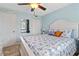 Bright bedroom with blue accents, a white bed frame, and a view of the closet and mirror at 1500 Park Beach Cir # 2F, Punta Gorda, FL 33950