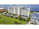 Aerial view of a waterfront condominium complex showcasing lush greenery and ample parking at 1500 Park Beach Cir # 2F, Punta Gorda, FL 33950