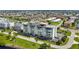 Low angle aerial of building shows roof top patio and parking close to waterfront at 1500 Park Beach Cir # 2F, Punta Gorda, FL 33950