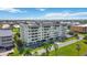 Low angle aerial of building shows roof top patio and parking close to waterfront at 1500 Park Beach Cir # 2F, Punta Gorda, FL 33950