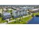 Low angle aerial of building shows roof top patio and parking close to waterfront at 1500 Park Beach Cir # 2F, Punta Gorda, FL 33950