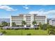 Stunning exterior of a beachfront condominium with meticulous landscaping and palm tree accents at 1500 Park Beach Cir # 2F, Punta Gorda, FL 33950