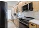 Well-equipped kitchen features stainless steel appliances, light cabinetry, and granite countertops at 1500 Park Beach Cir # 2F, Punta Gorda, FL 33950