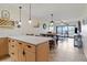 Open kitchen showcases granite countertops, a wine rack, and views to the water from the connected living area at 1500 Park Beach Cir # 2F, Punta Gorda, FL 33950