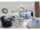 Well-lit living room with sliding glass doors to a balcony and coastal views at 1500 Park Beach Cir # 2F, Punta Gorda, FL 33950