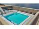 Rooftop pool with stairs, railings, furniture, and a view of the water at 1500 Park Beach Cir # 2F, Punta Gorda, FL 33950