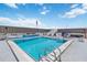 Clear blue rooftop pool featuring lounge seating and stair access with an American flag at 1500 Park Beach Cir # 2F, Punta Gorda, FL 33950