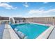 Inviting rooftop pool area featuring lounge chairs and stair access under a blue sky at 1500 Park Beach Cir # 2F, Punta Gorda, FL 33950