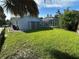 The backyard features a screened-in pool and a large grassy area perfect for outdoor activities at 1505 Kenmore St, Port Charlotte, FL 33952