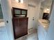 Bathroom featuring a vanity with marble countertop and dark wood apothecary cabinet at 1505 Kenmore St, Port Charlotte, FL 33952