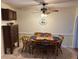 Cozy dining area with wood table, ceiling fan, and neutral wall color at 1505 Kenmore St, Port Charlotte, FL 33952
