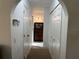 Clean hallway with closet space and archway to other rooms in the home at 1505 Kenmore St, Port Charlotte, FL 33952