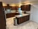 Well-equipped kitchen with tile floors, ample cabinets, and stainless steel appliances at 1505 Kenmore St, Port Charlotte, FL 33952