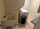 Laundry room with utility sink and modern washer and dryer featuring neutral toned tile floors at 1505 Kenmore St, Port Charlotte, FL 33952