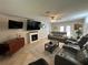 Spacious living room boasts a fireplace, multiple seating options, and natural light at 1505 Kenmore St, Port Charlotte, FL 33952