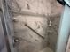 Close up of new shower with marble tile, grab bar, and built in shelves for toiletries at 1505 Kenmore St, Port Charlotte, FL 33952