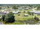 Neighborhood aerial showing home's location relative to street, neighboring houses, and waterway at 1596 Hayworth Rd, Port Charlotte, FL 33952