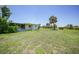 View of the house from the yard showcasing the screened lanai and outbuilding at 1596 Hayworth Rd, Port Charlotte, FL 33952