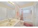Full bathroom features a tub, shower, and vanity at 1596 Hayworth Rd, Port Charlotte, FL 33952