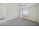 Clean bedroom with neutral carpet, ceiling fan, and ensuite bathroom access at 1596 Hayworth Rd, Port Charlotte, FL 33952
