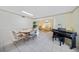 Open-concept dining area with tile floors, piano, and open layout to the living room at 1596 Hayworth Rd, Port Charlotte, FL 33952