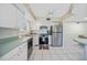 Updated kitchen with stainless steel appliances, white cabinetry and tile flooring at 1596 Hayworth Rd, Port Charlotte, FL 33952