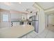 Bright kitchen features white cabinets, stainless steel appliances, and access to the backyard at 1596 Hayworth Rd, Port Charlotte, FL 33952