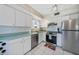 Well-maintained kitchen with white cabinets and stainless steel appliances for modern living at 1596 Hayworth Rd, Port Charlotte, FL 33952