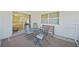 Open-air lanai seating area featuring chairs, table, and bench for enjoying the outdoors at 1596 Hayworth Rd, Port Charlotte, FL 33952