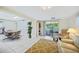 Open-concept living and dining area with sliding glass doors to a screened patio at 1596 Hayworth Rd, Port Charlotte, FL 33952