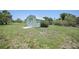 Outbuilding with light siding and doors on a lush lot at 1596 Hayworth Rd, Port Charlotte, FL 33952