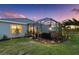 Landscaped backyard features a screened patio and verdant lawn at 16032 Galiano Ct, Punta Gorda, FL 33955