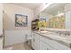 Well-lit bathroom with a granite countertop vanity and decorative wainscoting for a clean, classic look at 16032 Galiano Ct, Punta Gorda, FL 33955