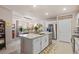 Open-concept kitchen with a large island and a stainless steel refrigerator at 16032 Galiano Ct, Punta Gorda, FL 33955