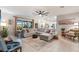 This light-filled living room features tile floors, ceiling fan, and a comfortable sectional sofa at 16032 Galiano Ct, Punta Gorda, FL 33955