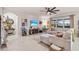 A beautifully decorated living room with a large sectional sofa, tv, and ceiling fan at 16032 Galiano Ct, Punta Gorda, FL 33955