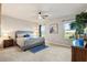 Serene primary bedroom featuring a comfortable bed, neutral tones, and natural light from two windows overlooking the yard at 16032 Galiano Ct, Punta Gorda, FL 33955