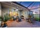 Charming screened-in patio with furniture, ceiling fan, and plants at 16032 Galiano Ct, Punta Gorda, FL 33955