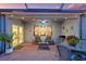 Relaxing screened-in patio with wicker seating and string lights at 16032 Galiano Ct, Punta Gorda, FL 33955